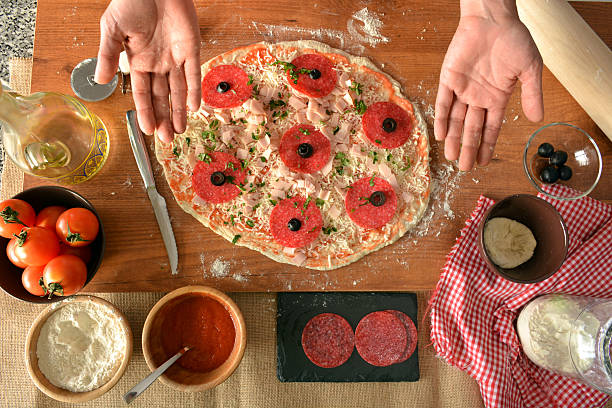 istock woman hands cooking pizza at home 478306556