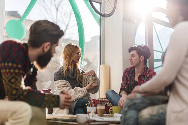 istock Young happy adults having a break in cafe and talking. 478306770