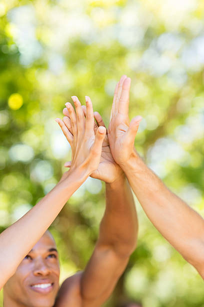istock Marathon Runners Giving High-Five In Park 478310064