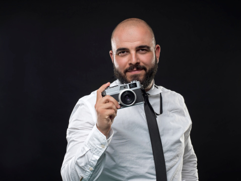 Portrait of a photographer over black background