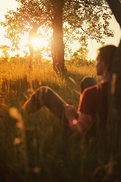 istock Man walking on slackline in the meadow at sunset. 478311274