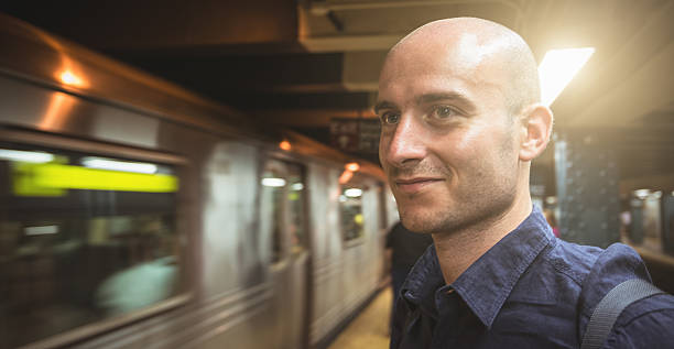 istock Smiling man inside the nyc subway station 478312091