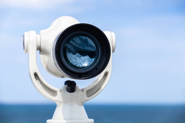 istock White paid telescope stands on sea coast 478314064