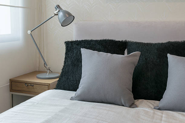 istock bedroom interior design with grey pillows on white bed 478315078