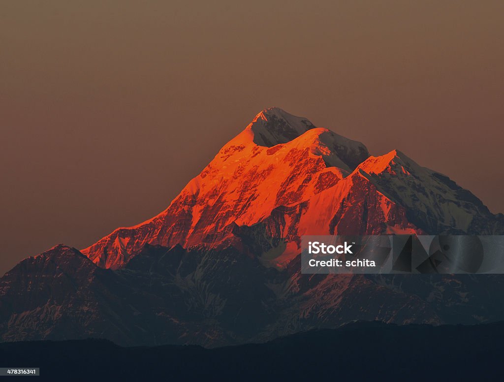 sunset over Mountain "Trishul" Snow clad  mountain "Trishul" is composed three closely placed  peaks. It is located in "Kumaon' Region of Indian Himalaya. The mountain displays various changing colours during sunset and sunrise Asia Stock Photo