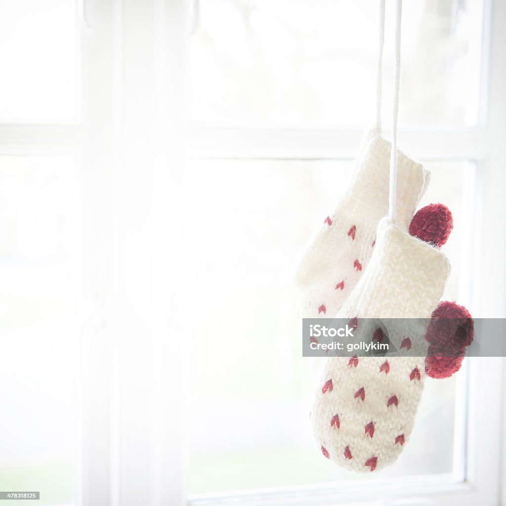 Love mittens hanging by the window Handcrafted love mittens hung by the window Heart Shape Stock Photo