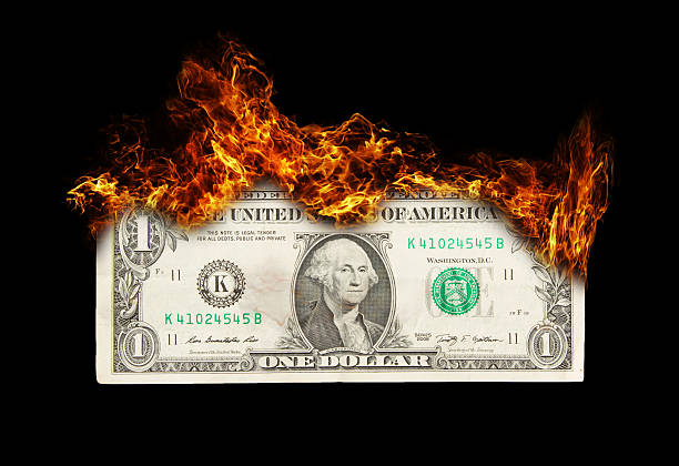 istock Burning dollar bill symbolizing careless money management 478318533