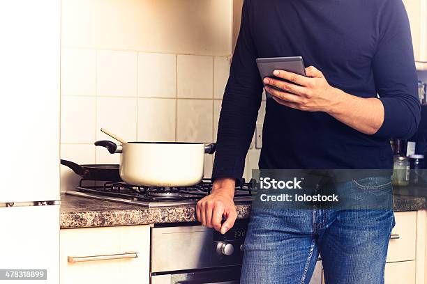 Dreader Cooking Man Cooking And Reading On His Ereader Stock Photo - Download Image Now ...