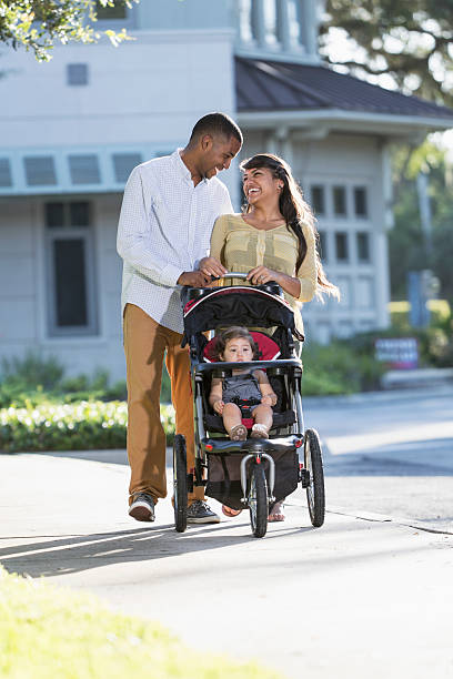 istock Young family with baby in stroller 478319175