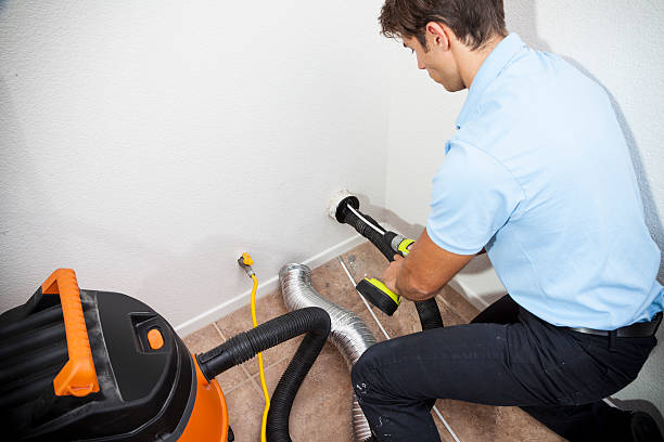 Dryer Vent Cleaning Man cleaning dryer vent in home. dryer stock pictures, royalty-free photos & images
