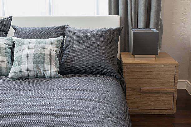 istock bedroom interior design with checked green pillows on grey bed 478319742