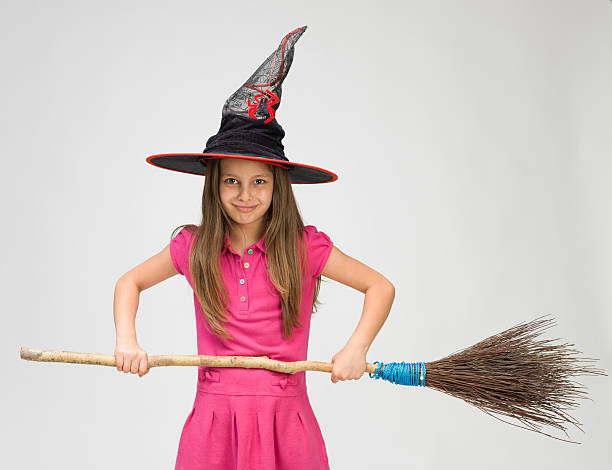 istock Little girl with witch's hat and real broom 478320163
