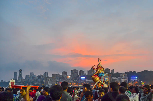 Mumbai, India - September 17, 2013: Devotees bringing Hindu God Ganesha into the ocean during Ganesha Festival