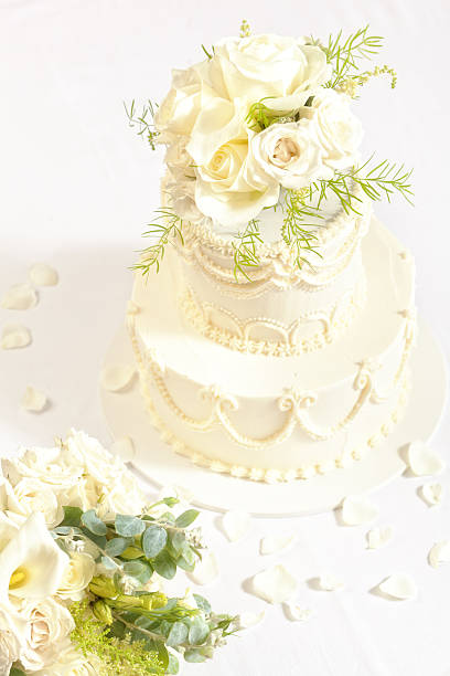 istock Tiered Wedding Cake with White Roses Bouquet 478321487