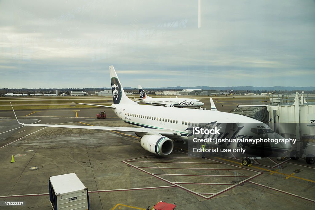 Alaska Airlines Flight Boarding Portland, Oregon, USA - January 27, 2014: Alaska Airlines flight being boarded by passengers just before takeoff at Portland International Airport. Airplane Stock Photo