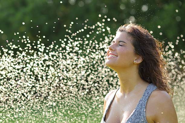 istock Beautiful woman breathing under a water jet 478322525