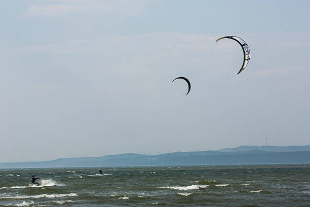 Kiteboarders Ride Strong Wind stock photo