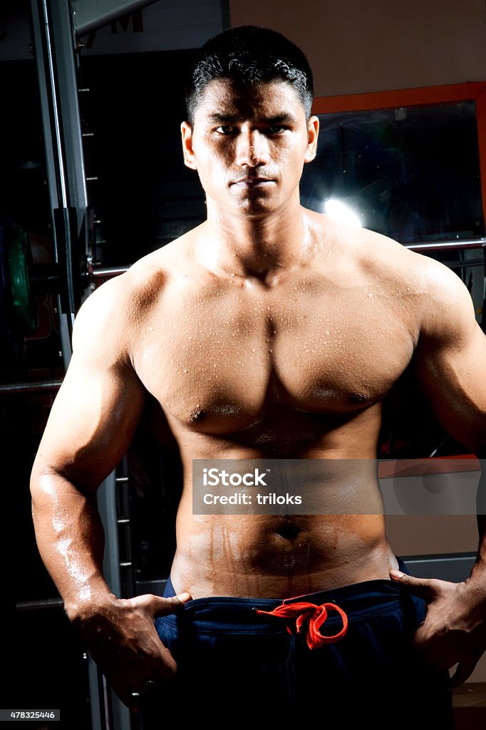 Young male macho standing with his arms akimbo Bodybuilder posing 2015 Stock Photo