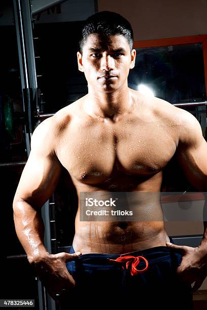 Young Male Macho Standing With His Arms Akimbo Stock Photo - Download Image Now - 2015, Abdominal Muscle, Active Lifestyle