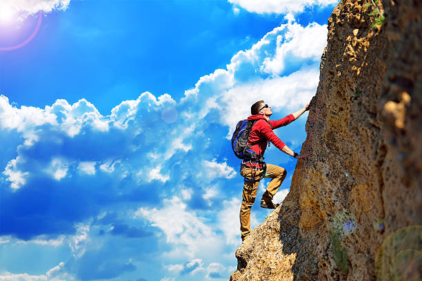 climber with backpack climber with backpack hanging on the rock climbing up a hill stock pictures, royalty-free photos & images