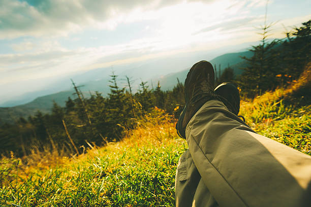 Man laying on the ground in a grass field. 