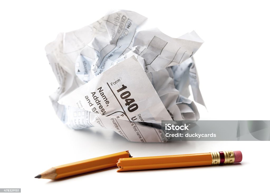 Crumpled 1040 U.S. Tax Return Form and Broken Pencil A crumpled 1040 form with broken pencil on white background. Tax Form Stock Photo