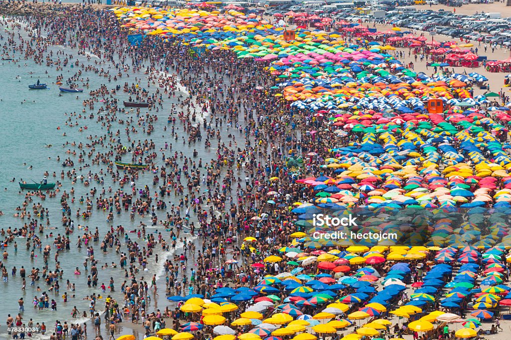 Crowded beach crowded beach with umbrellas and people in the water Crowded Stock Photo