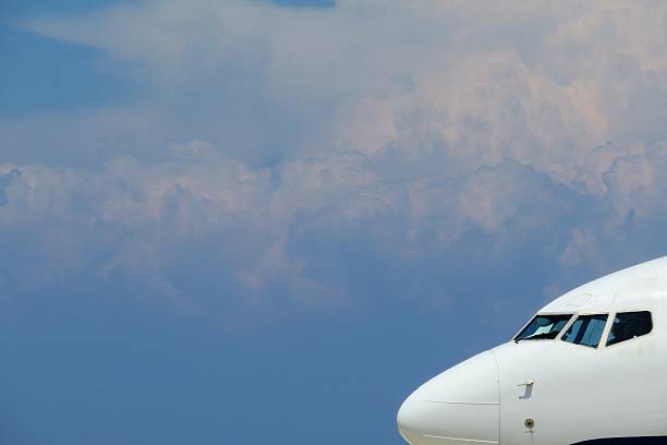 istock Airplane flying in front of blue sky 478330802