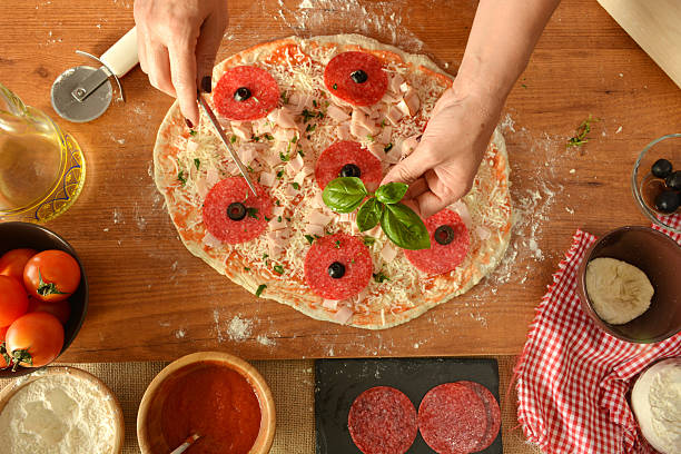 istock woman hands cooking pizza at home 478331464