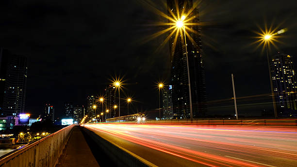 istock light trails on the modern building background in Bangkok Thailand 478335234