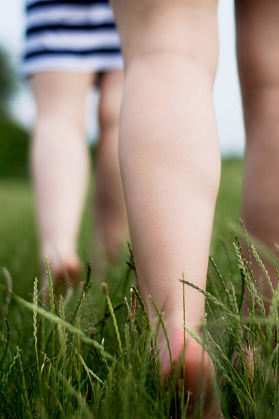 istock Barefoot girls in skirts on grass 478335500