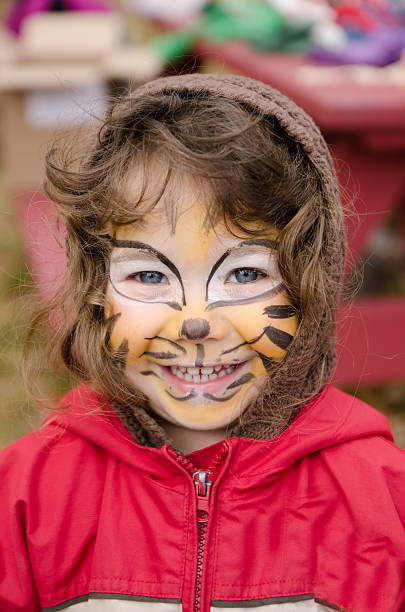 istock young girl with tiger make-up making a big smile 478336029