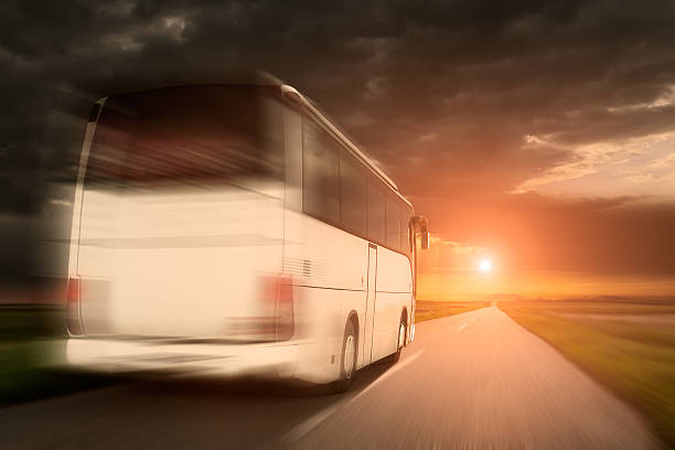 istock White bus in speed driving on an empty asphalt road 478336246