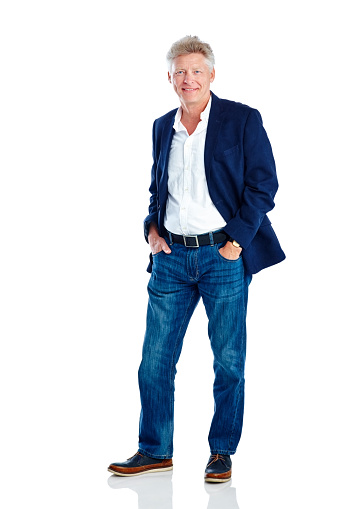 Studio shot of handsome mature man posing in smart casuals on white background