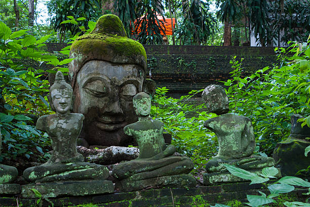 istock Broken statues of Buddha in a forest temple 478337211