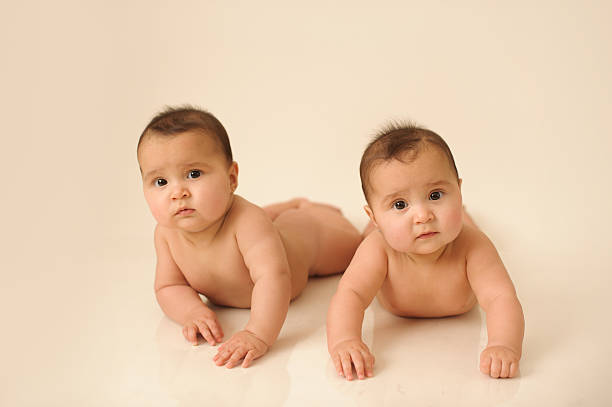 istock Two Twin Sisters Laying Together 478338587