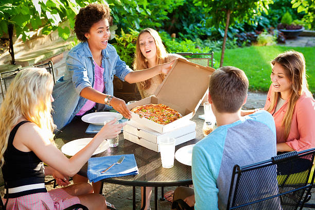 istock Friends Having Pizza Dinner in Outdoor Background Patio 478340440