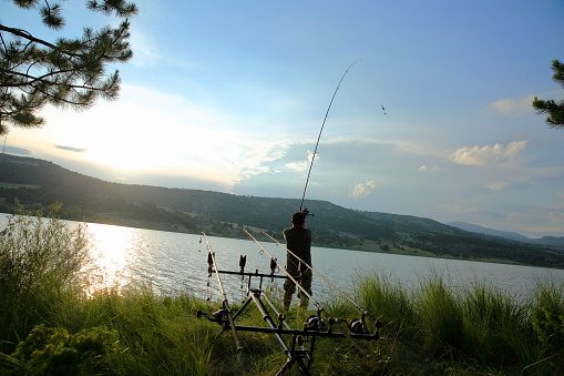 Man fishing on a lake.