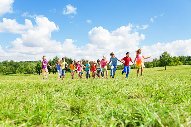 istock Large group of kids running in the park 478342123