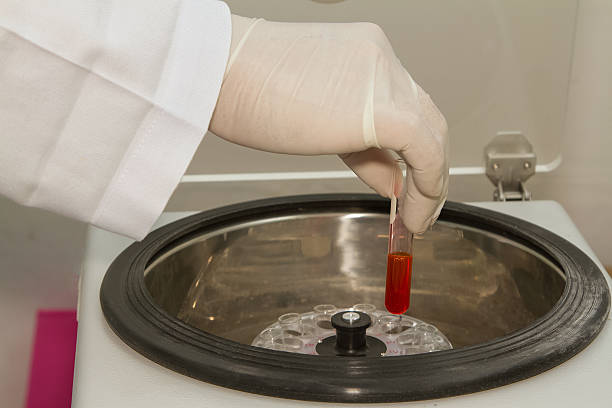 istock laboratory assistant working with electronic blood centrifuge in 478345714
