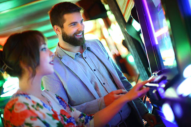 istock Couple playing slots in casino. 478345748