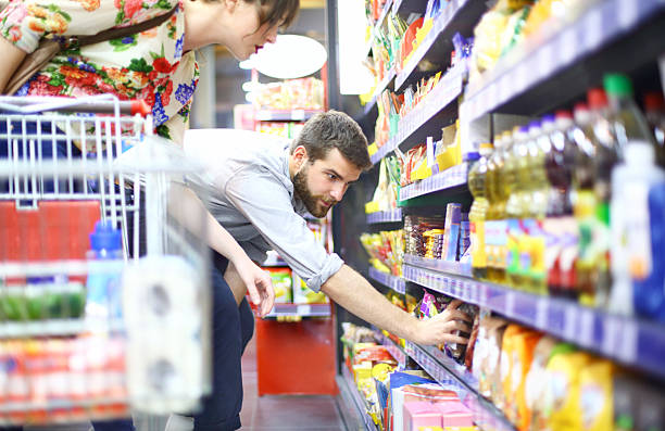 People shopping in supermarket.