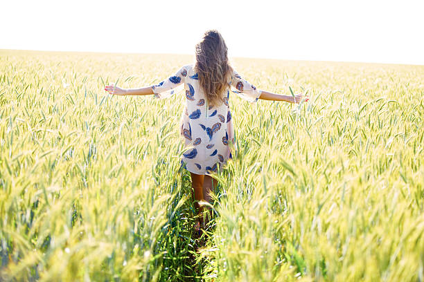 istock Woman with arms outstretched in wheat field 478346517