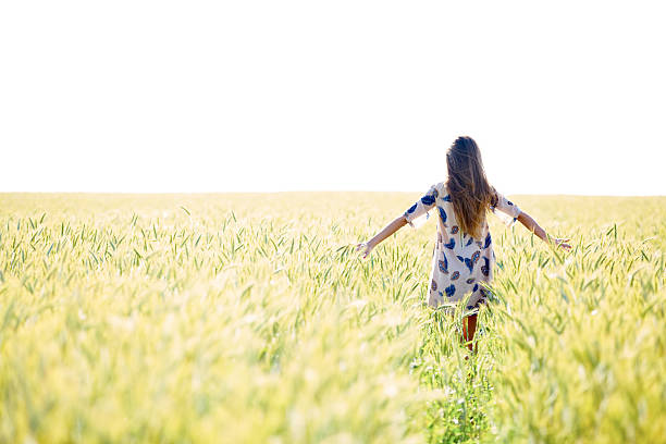 istock Woman with arms outstretched in wheat field 478346573