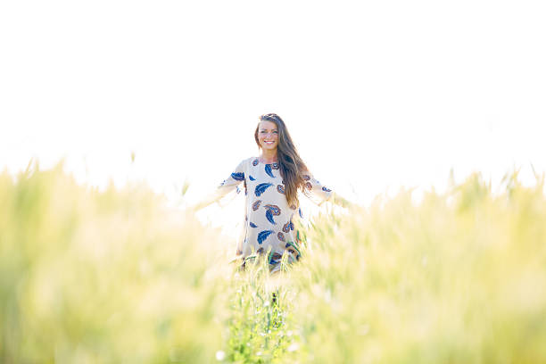 istock Woman with arms outstretched in wheat field 478346719