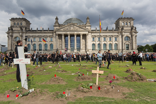 Berlin,Germany, June 21, 2015 : Graves in front of the german parliament. Activists announced that they would exhume the bodies of refugees who died in the Mediterranean Sea and bury them  in Berlin.