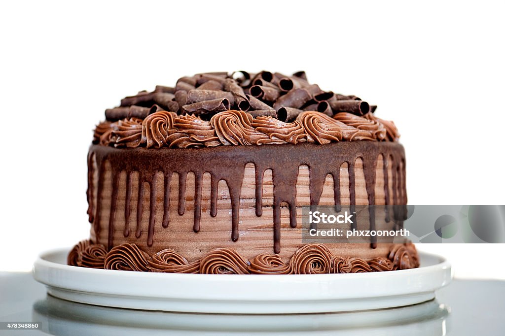 Chocolate Cake with Chocolate Fudge Drizzled Icing and Chocolate Curls Chocolate Cake with Chocolate Fudge Drizzled Icing and Chocolate Curls on White Backdrop Cake Stock Photo