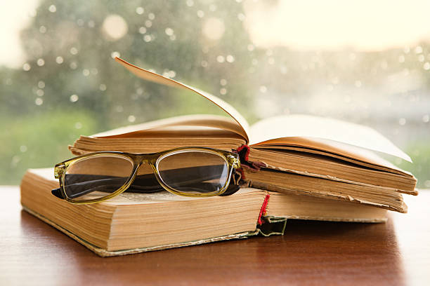 istock glasses and books over the window 478349104