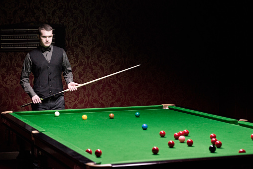 Professional snooker player evaluating the situation. Toned image