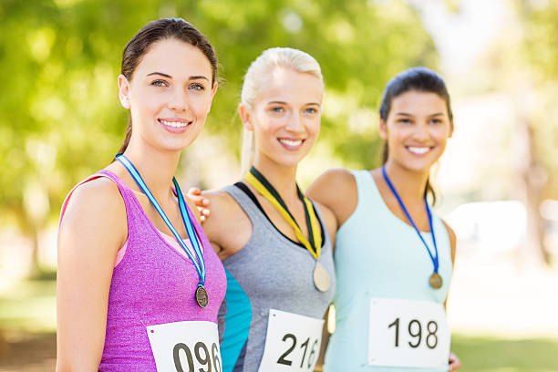 istock Beautiful Marathon Runners With Medals In Park 478351720